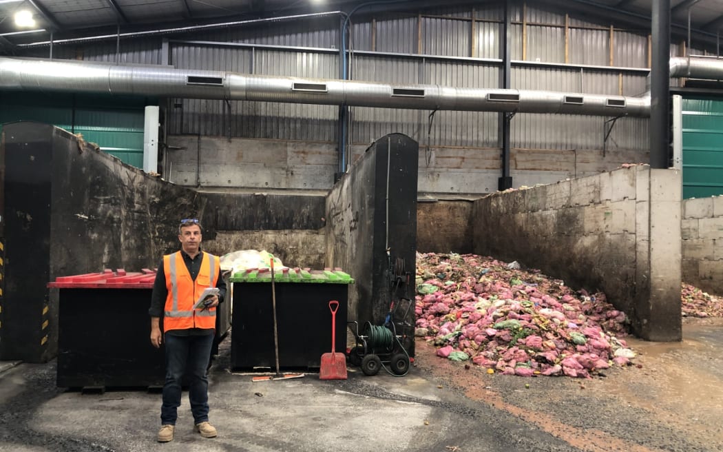 Ecogas co-founder Andrew Fisher standing next to a pile of food waste at the company's Papakura plant