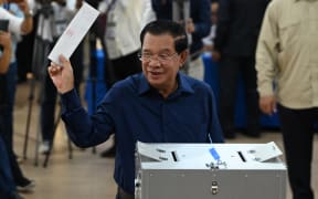 Cambodia's Prime Minister Hun Sen prepares to cast his vote at a polling station in Kandal province on July 23, 2023 during the general elections. (Photo by TANG CHHIN SOTHY / AFP)