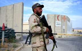An Afghan National Army (ANA) soldier stands guard at the gate of a hospital inside the Bagram US air base after all US and NATO troops left, 5 July 2021.