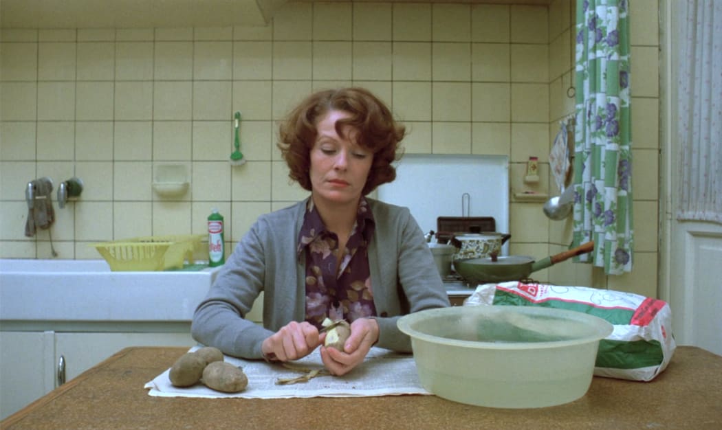 Delphine Seyrig as Jeanne Dielman peels potatoes for dinner on Day One of Jeanne Dielman, 23 quai du Commerce, 1080 Bruxelles (Chantal Akerman).