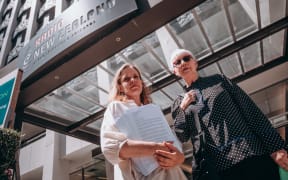 Margaret Guldborg and Elizabeth Kerr deliver a 26,000 signature petition to RNZ house in Wellington calling for a halt to proposed redundancies at RNZ Concert