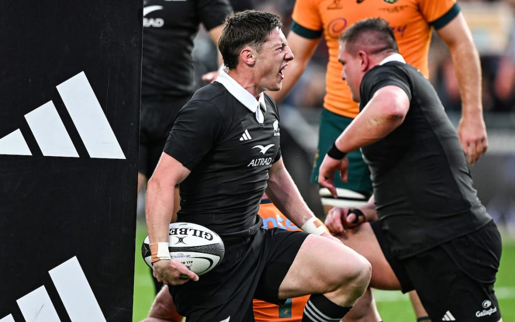 Cam Roigard celebrates his try.