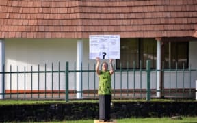 Moira Maiava holding her one woman protest for better health care in American Samoa