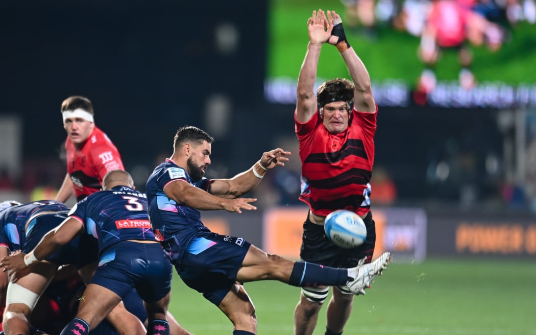 Ryan Louwrens of the Rebels kicks under pressure from Scott Barrett of the Crusaders during the Super Rugby Pacific match, Crusaders Vs Rebels, at the Apollo Projects Stadium, Christchurch, New Zealand, 26th April 2024. Copyright photo: John Davidson / www.photosport.nz