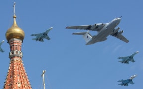 A Russian A-50 plane and Su-27 fighter jets fly over St. Basil's cathedral during the Victory Day parade in Moscow on May 9, 2010. In a moment of huge symbolism, soldiers from Britain, France, Poland and the United States paraded on the square's famous cobbles in Moscow at the same time as nuclear-capable missiles that once would have been aimed at Western states. Britain and the United States were the key allies of the Soviet Union in World War II but became bitter foes postwar. France and Poland were occupied by the Nazis but their exiled troops played a major role in the Allied effort.    AFP PHOTO / ANDREY SMIRNOV

==CORRECTS AIRPLANES IN CAPTION== (Photo by ANDREY SMIRNOV / AFP)
