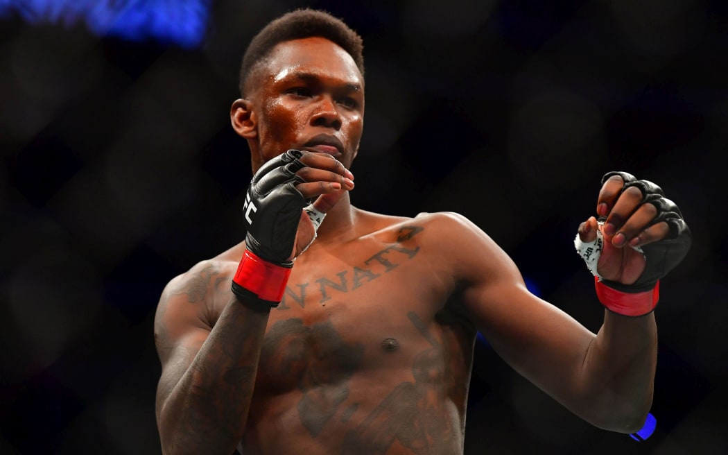 Mar 7, 2020; Las Vegas, Nevada, USA; Israel Adesanya (red gloves) before the match against Yoel Romero (blue gloves) during UFC 248 at T-Mobile Arena. Mandatory Credit: Stephen R. Sylvanie-USA TODAY Sports