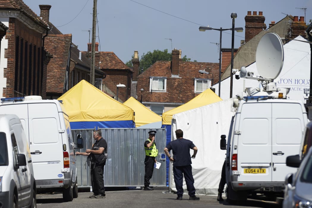 Police officers stand guard at a cordon near Rollestone Street, in Salisbury, in 2018 after the exposure of a British couple to the same nerve agent used against former Russian double agent Sergei Skripal. caption