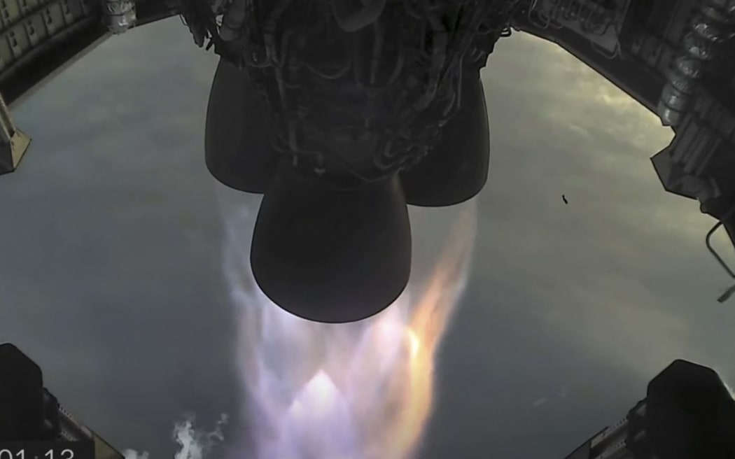 This photo screengrab made from SpaceX's live webcast shows the three Merlin engines on the Starship SN11 as it took to the skies over Texas on March 30, 2021 following a 24-hour delay.