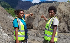 The Santo Sunset Environment Women's Network (SSEWN) team pointing at the landslide.