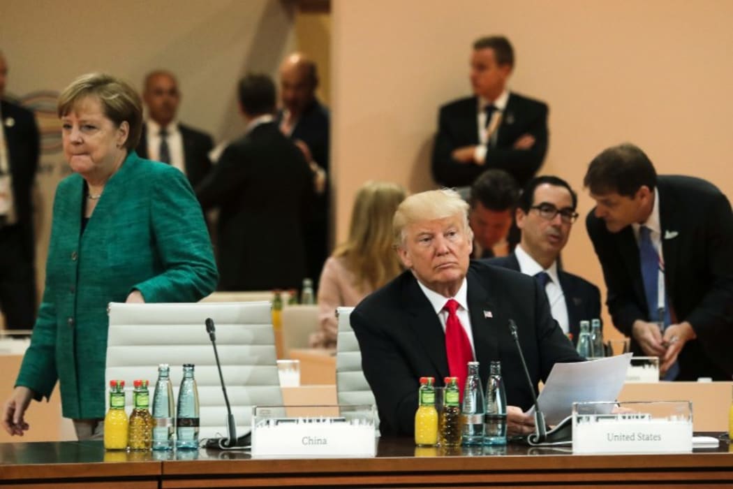 American president Donald Trump and German chancellor Angela Merkel attend G20 talks.