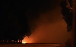 A Ukrainian army checkpoint burns outside Mariupol.