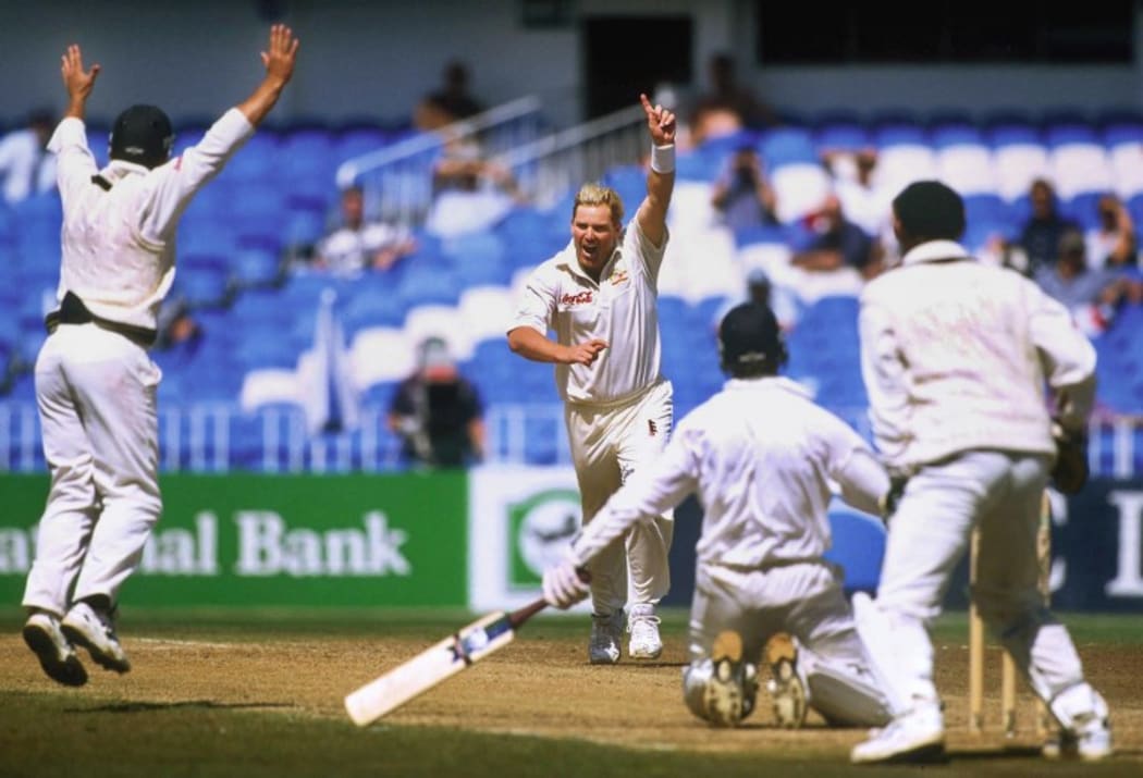 Shane Warne celebrates his test wicket-taking record of 355 on the last day of the first Test match between Australia and New Zealand at Eden Park 15 March 2000.