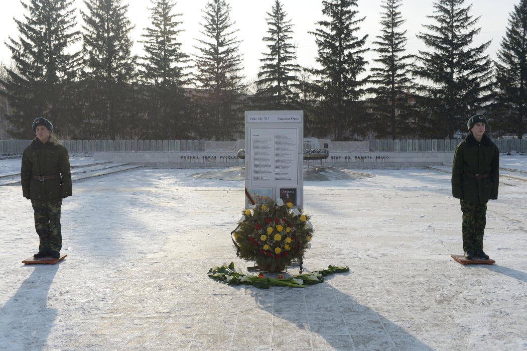 Flowers are placed at an eternal flame and list of the dead in memorial after the Saratov Airlines crash.