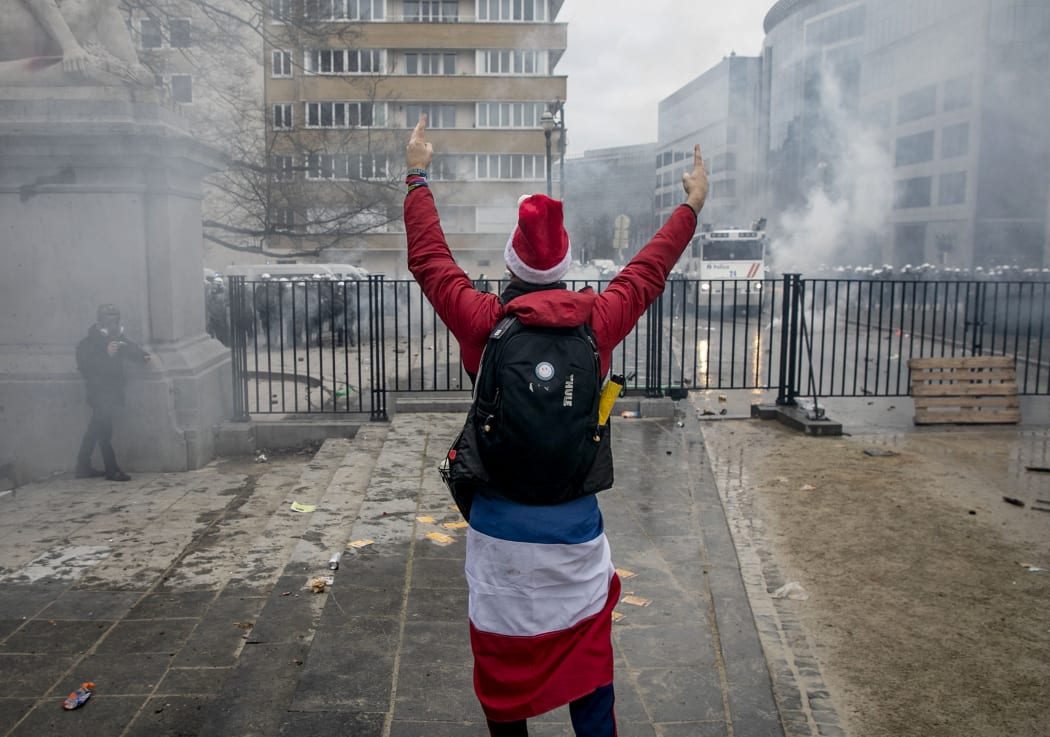 A protester stands in front of police during a demonstration for "freedom, democracy and human rights" organised by the alliance Europeans United in Brussels.