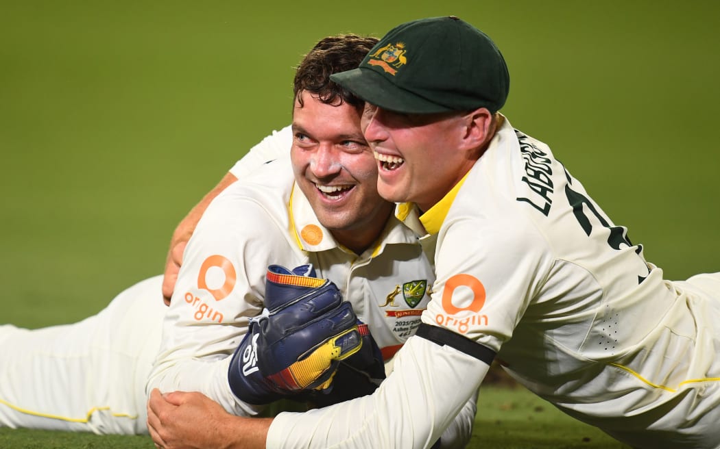 Alex Carey of Australia celebrates taking a catch with team mate Marnus Labuschagne, Ashes series, 2025.