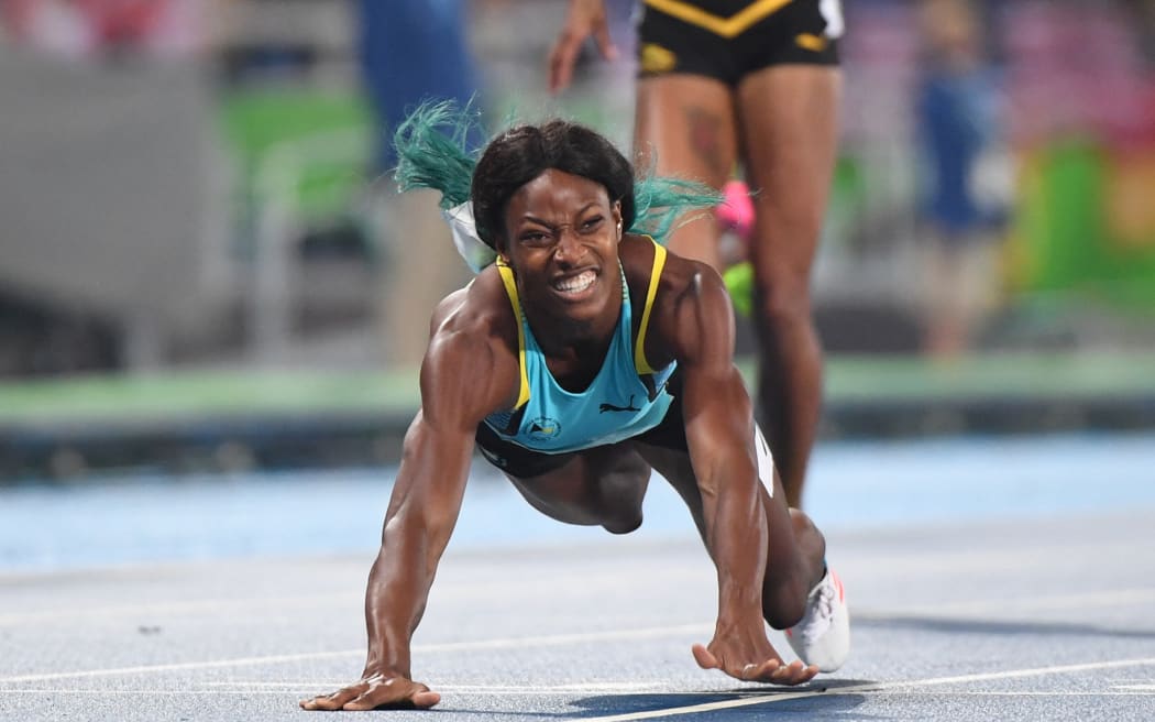 Bahamas's Shaunae Miller crosses the finish line to win the Women's 400m Final during the athletics event at the Rio 2016 Olympic Games at the Olympic Stadium in Rio de Janeiro on August 15, 2016. (Photo by OLIVIER MORIN / AFP)