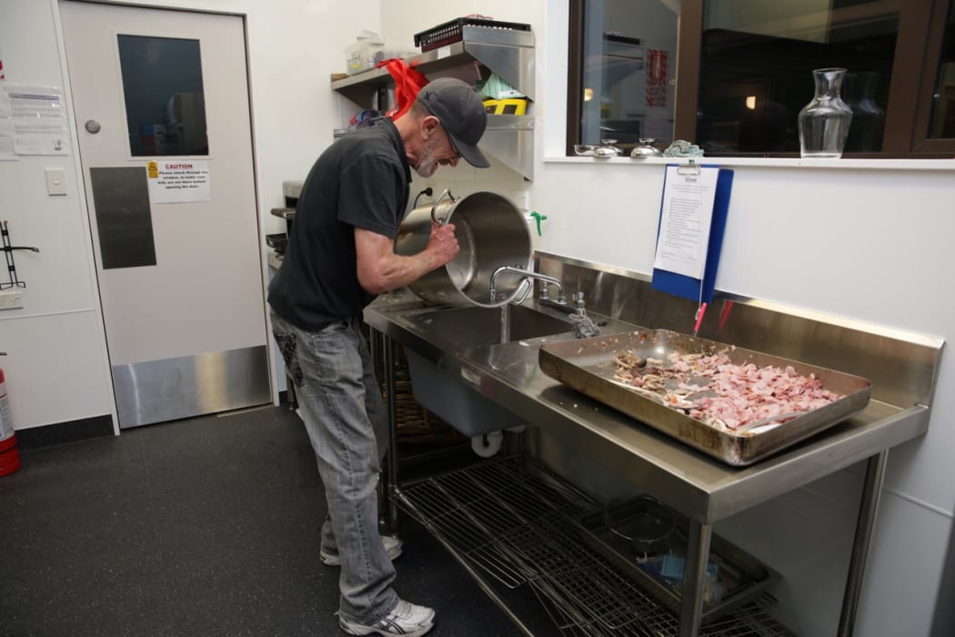 After feeding 700 people the clean up begins at Takahanga marae, local business owner Dexarelli helps out.