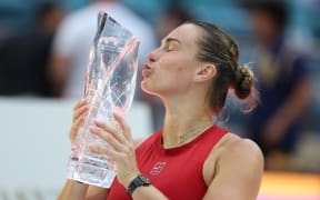 MIAMI GARDENS, FLORIDA - MARCH 29: Aryna Sabalenka celebrates with the Butch Buchholz Trophy following her victory against Jessica Pegula of the United States in the women's final on Day 12 of the Miami Open Presented by Itau 2025 at Hard Rock Stadium on March 29, 2025 in Miami Gardens, Florida.   Al Bello/Getty Images/AFP (Photo by AL BELLO / GETTY IMAGES NORTH AMERICA / Getty Images via AFP)
