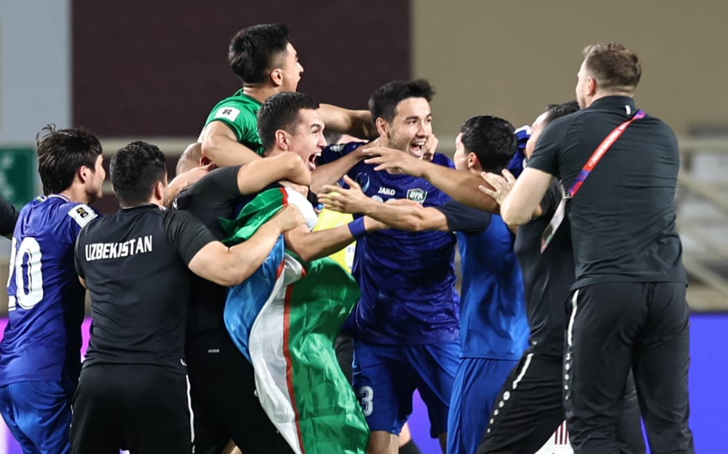 Uzbekistan's players celebrate after their 2026 FIFA World Cup Asian Qualifier football match against the United Arab Emirates ended in a draw, qualifying them for the World Cup for the first time.