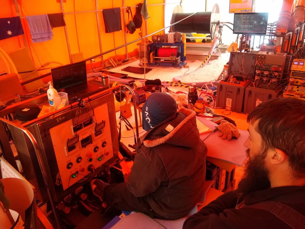Extensive control systems and infrastructure are needed to run the hot water drill being used for ice research in Antarctica. Hedley Berge and Tim McPhee, from Victoria University of Wellington are monitoring the system.