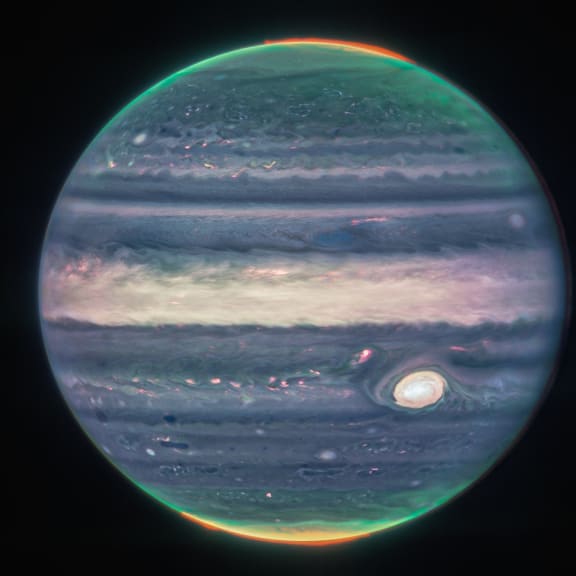 In this image obtained from NASA and taken by the James Webb Space Telescope, shows Jupiter's weather patterns, tiny moons, altitude levels, cloud covers and auroras at the northern and southern poles. (Photo by Handout / NASA / AFP) / RESTRICTED TO EDITORIAL USE - MANDATORY CREDIT "AFP PHOTO / NASA, ESA, CSA, Jupiter ERS Team; image processing by Judy Schmidt" - NO MARKETING NO ADVERTISING CAMPAIGNS - DISTRIBUTED AS A SERVICE TO CLIENTS