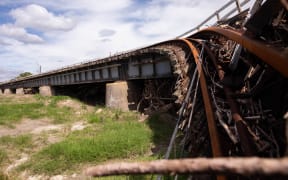 A rail bridge was destroyed by an overflowing river just south of Napier