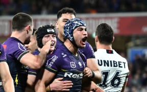 Jahrome Hughes of the Storm celebrates scoring a try