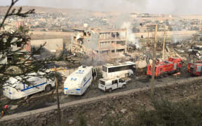 Turkish police and firefighters parked near the damaged police headquarters in Cizre.