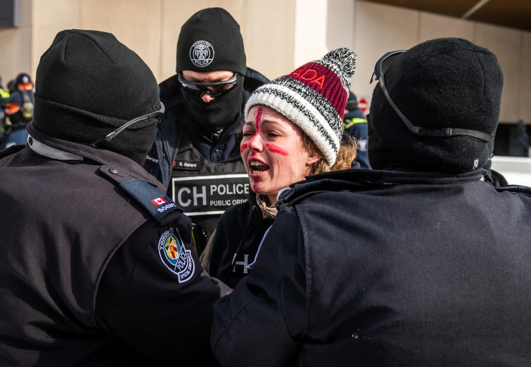 Police arrest a demonstrator against Covid-19 mandates in Ottawa on 18 February 2022.