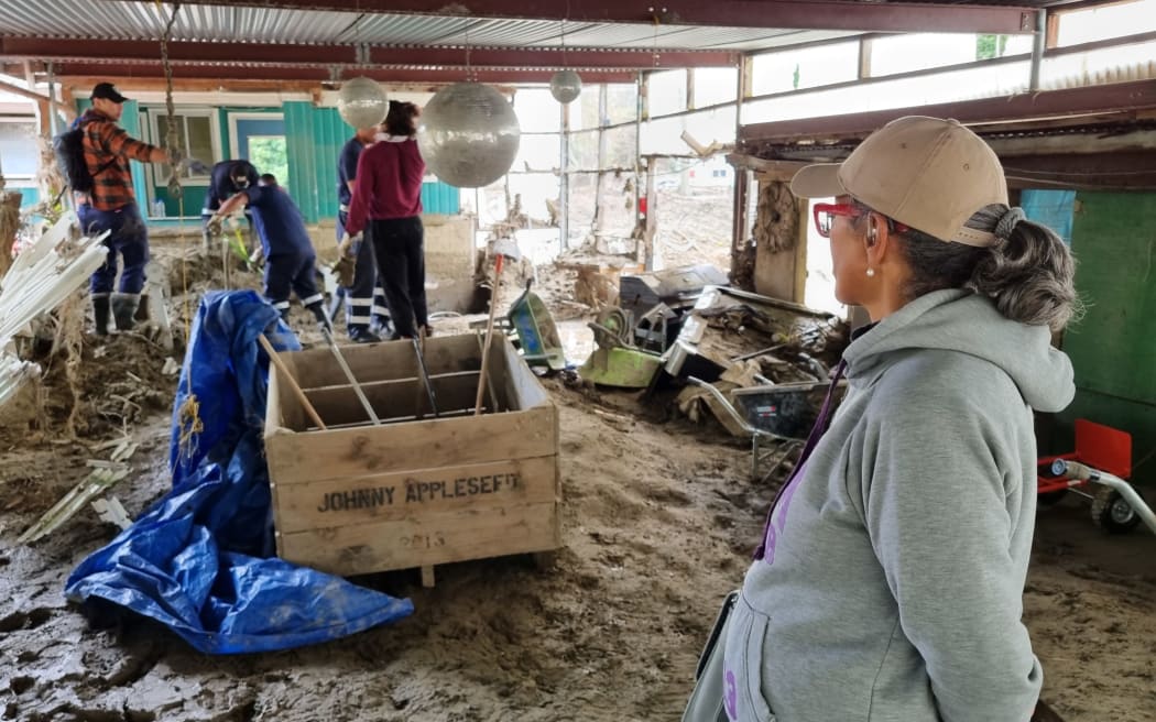 Fijian firefighters and other volunteers help clean out Rawinia Anderson's Esk Valley family home.