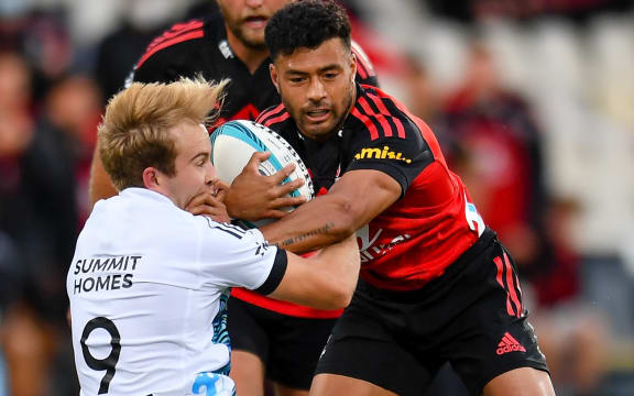 Richie Mo'unga fends in Super Rugby Pacific at Christchurch versus the Chiefs, March 2022