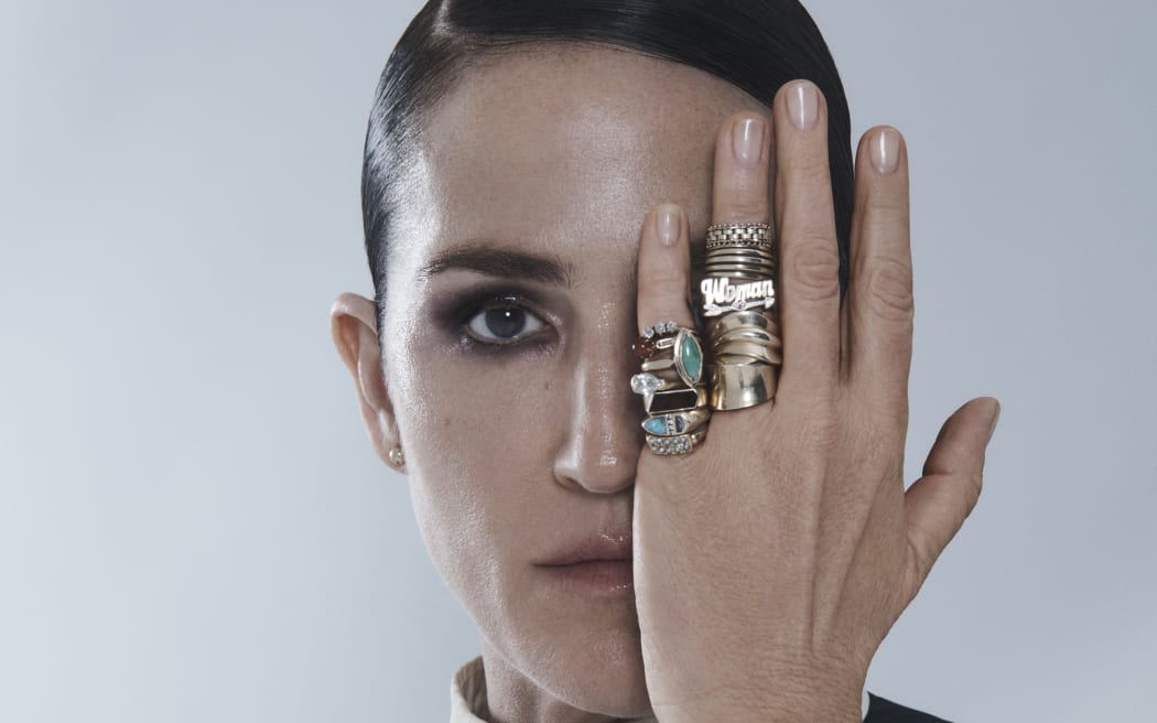 Portrait of Joan covering one eye wearing heavy rings