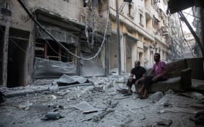 Aleppo's rebel-controlled neighbourhood of Karm al-Jabal on 18 September following an air strike.