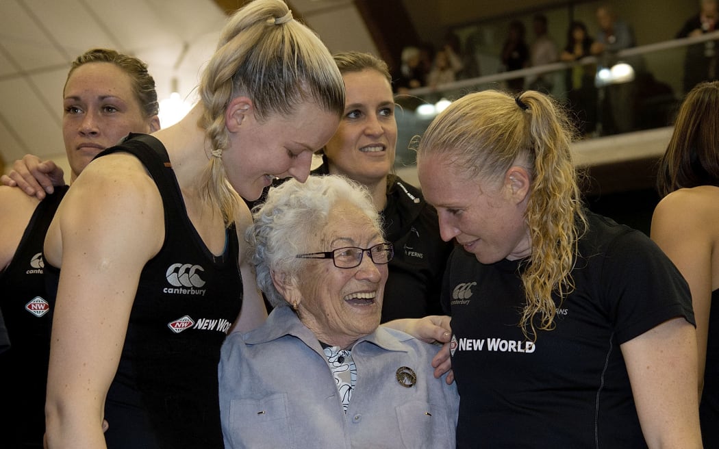 Taini Jamison is flanked by Silver Ferns players Katrina Grant (L) and Laura Langman.