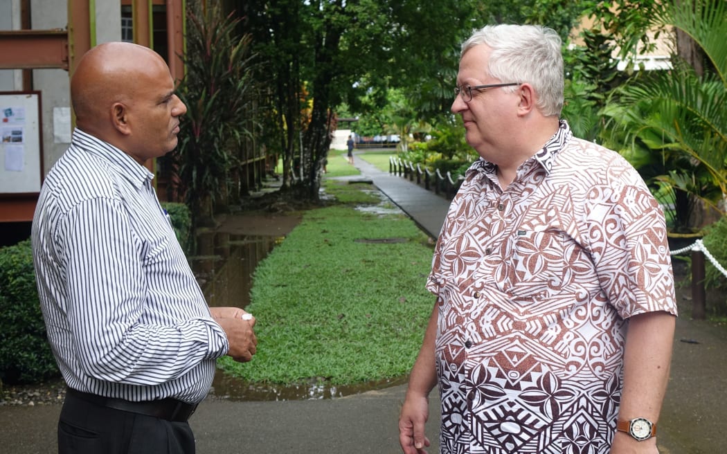 Unitech vice-chancellor Albert Schram (right) talks to a colleague on the institution's Lae campus