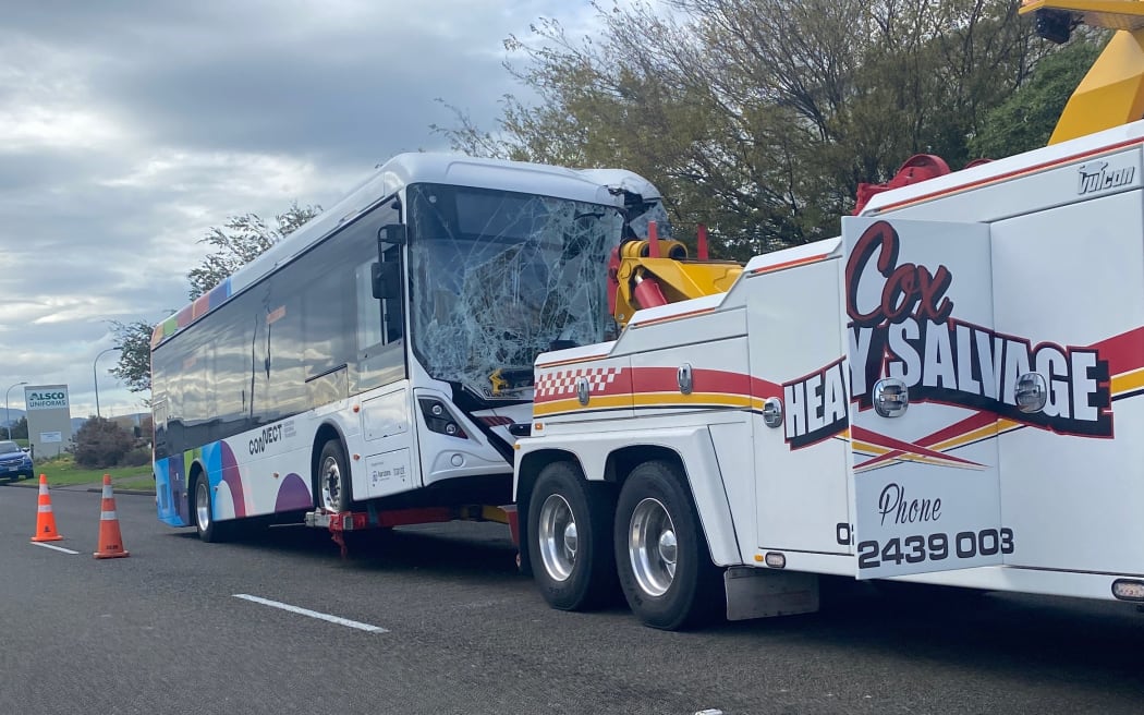The Palmerston North bus being taken away on a tow truck after the crash.