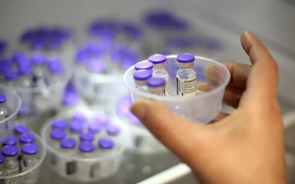 A nurse takes vials of Comirnaty vaccine by Pfizer-BioNTech against Covid-19 out of a fridge at the Baleone vaccine centre in Ajaccio on the French Mediterranean island of Corsica, on May 13, 2021.