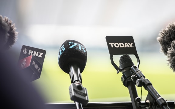 Microphones at a press conference showing RNZ, Newstalk ZB and Today FM