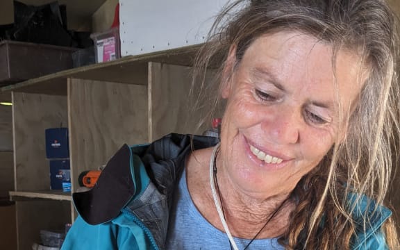 Project co-ordinator Marian Milne holds a fluttering shearwater chick – they were weighed daily, with their wings measured every second day – to get a sense of how much they needed to be fed and when they were ready to fly.