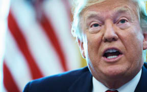 US President Donald Trump in the Oval Office before signing an executive order for sanctions on Iran's supreme leader.