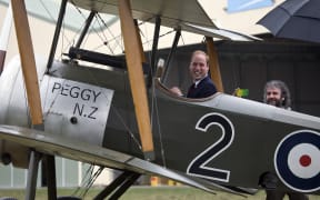 Prince William in the cockpit of a replica Sopwith Pup with Sir Peter Jackson.