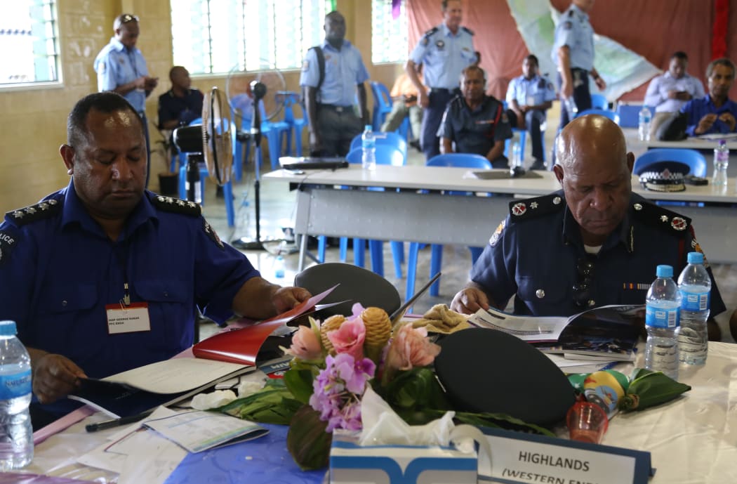 Senior figures in the Papua New Guinea police force: George Kakas (Enga Provincial Police Commander) and Teddy Tei (former assistant Police Commissioner)