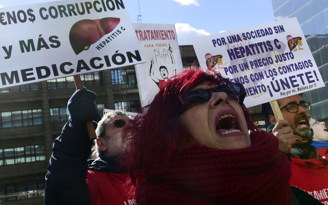 Hepatitis C patients and supporters demonstrate against high drug prices outside US laboratory Gilead Sciences office in Madrid.