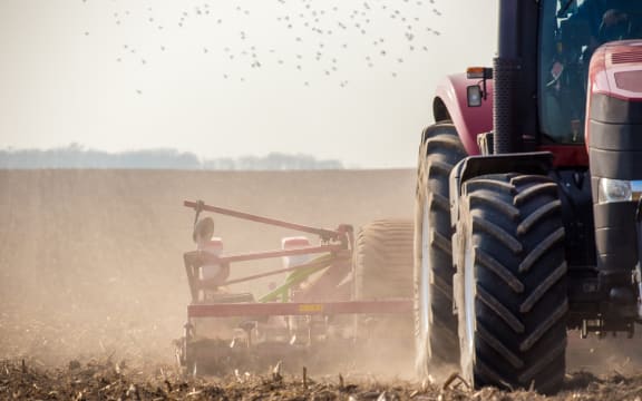 The tractor harvester working on the field