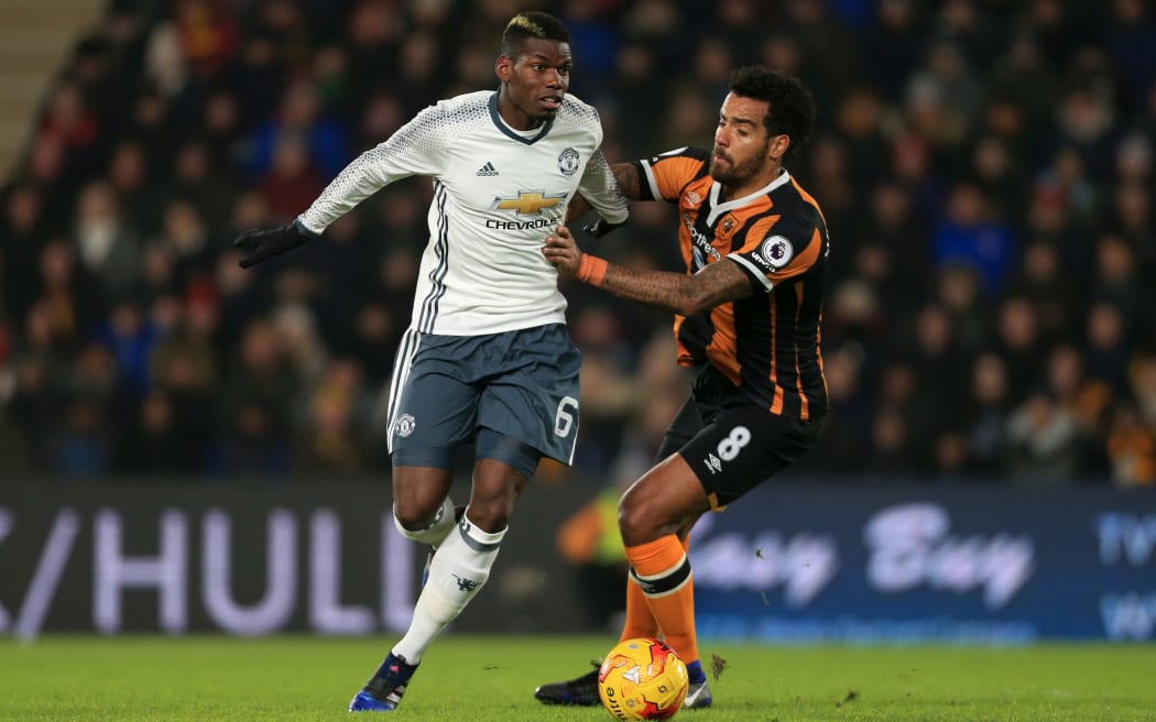 Manchester United's Paul Pogba and Tom Huddlestone of Hull City.