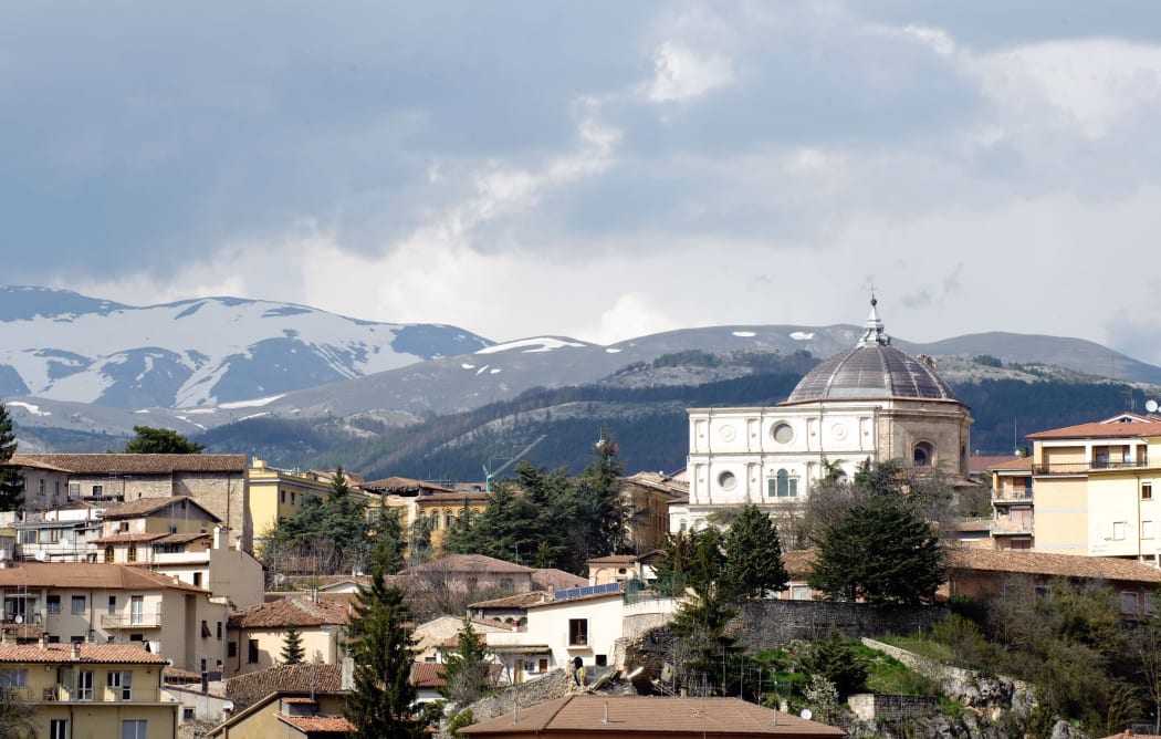 A view of a church, right, with its bell tower destroyed on 7 April 2009 in the centre of L'Aquila - a day after the earthquake.