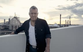 Jimmy Barnes overlooking an industrial site