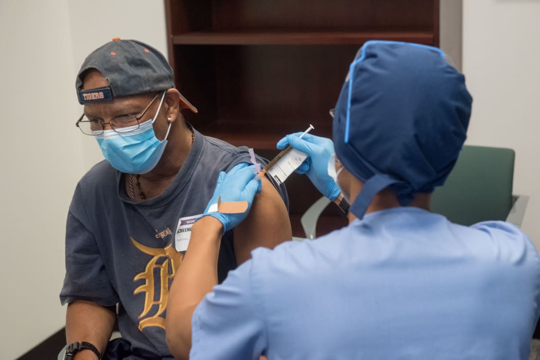 In this file image courtesy of the Henry Ford Health System, volunteers are given the Moderna mRNA-1273 Coronavirus Efficacy (COVE), on 5 August, 2020, in Detroit, Michigan.
