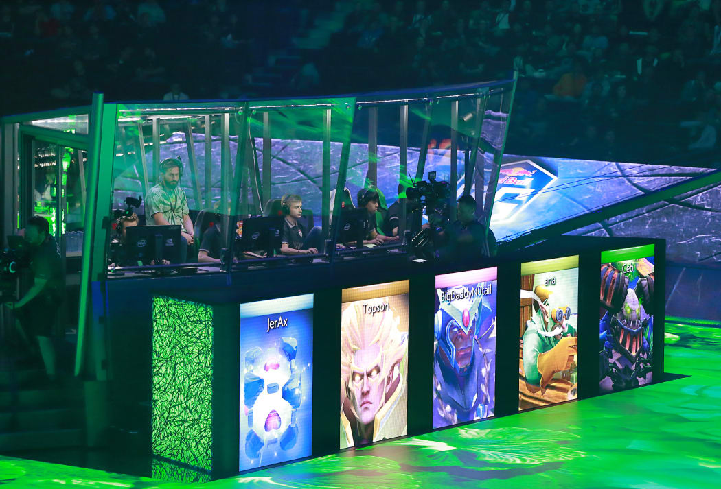 Members of OG sit in their booth as they play against PSG.LGD in their grand final Dota 2 match of The International 2018 at Rogers Arena on 25 August, 2018 in Vancouver, Canada.