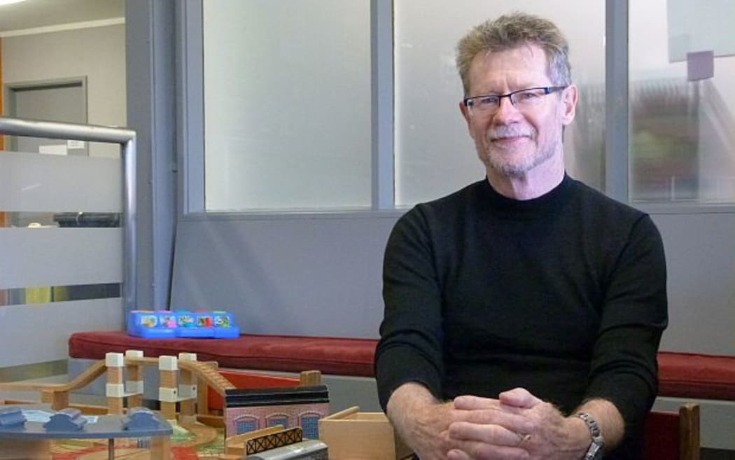 The Ministry of Health's Advisor on Child and Youth Health,  Pat Touhy, sits next to toy train set in outpatients